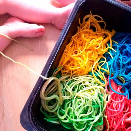 Imagen de niño manipulando espaguettis de colores